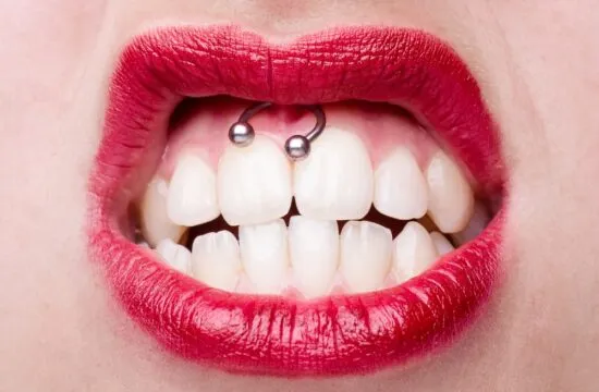 Smiley,Piercing,Detail,With,Snarling,Woman's,Mouth